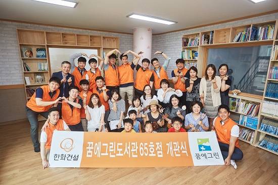 지난 7월27일 한화건설 봉사단과 지역주민들이 꿈에그린 도서관 65호점 개관식을 마치고 기념사진을 찍고 있다. ⓒ 한화건설