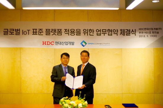 HDC현대산업개발 권순호 대표(오른쪽)와 OCF 박준호 상임이사가 글로벌 IoT표준 플랫폼 적용을 위한 업무협약식에서 기념촬영 하고 있다. ⓒ HDC현대산업개발
