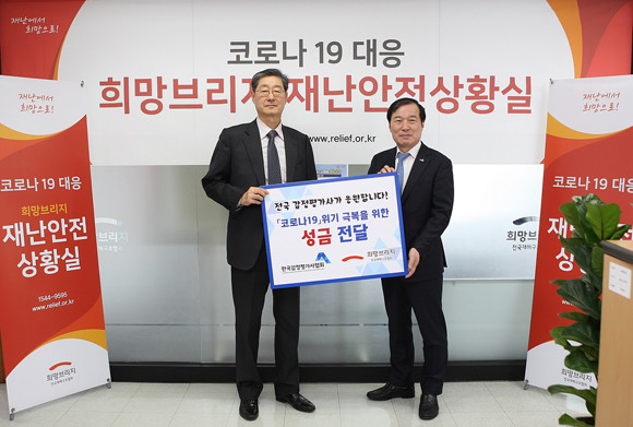 코로나19 위기 극복을 위한 성금 전달 후 송필호 희망브리지 전국재해구호협회 회장(왼쪽)과 김순구 한국감정평가사협회 회장(오른쪽)이 기념촬영을 하고 있는 모습. ⓒ 한국감정평가사협회
