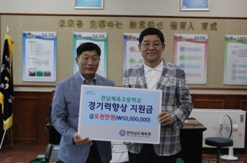 김홍식 전남체육회 상임부회장이 염세철 전남체고 교장에게 훈련비를 전달하고 있다. ⓒ 전남체육회