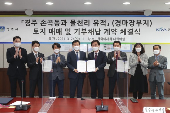 경주시와 한국마사회가 24일 한국마사회 사무실에서 경주 경마장부지를 경주시에 이전 하는 계약을 체결하고 관계자와 사진을 찍고 있다. ⓒ 경주시