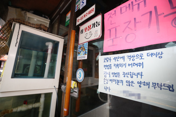 지난 2일 서울 시내 한 식당에 사회적 거리두기 4단계 격상으로 인한 영업 중단 안내문이 붙어있다. ⓒ 연합뉴스