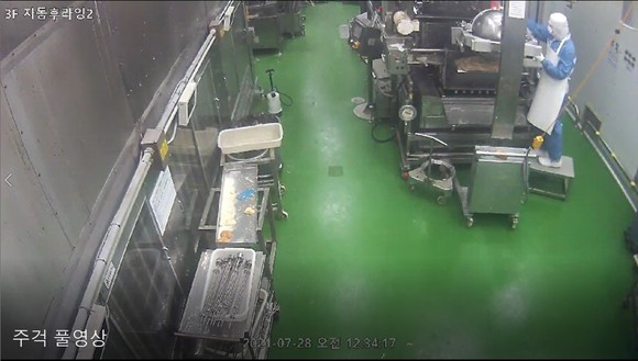 지난 7월28일 던킨 안양공장 CCTV 영상 중 일부. 비알코리아 측은 "한 직원이 주걱으로 장비에 맺힌 유증기를 긁어내고 있다"며 최근 발생된 '던킨 위생 불량' 영상의 조작 가능성을 제기했다. ⓒ 비알코리아
