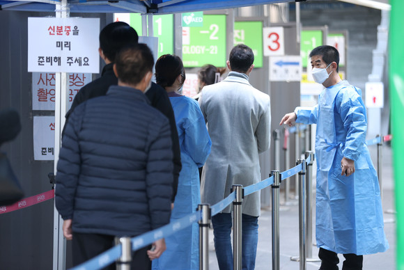19일 오전 서울 용산구보건소에 마련된 선별진료소를 찾은 시민들이 검사를 받기 위해 줄을 서고 있다. ⓒ 연합뉴스