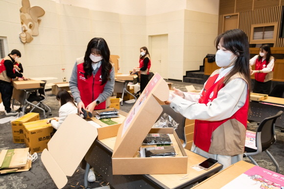17일 롯데월드 임직원들로 구성된 샤롯데 봉사단이 로티하우스 로티홀에서 홀몸 어르신들에게 전달할 <드림溫박스>를 포장하고 있다. © 롯데월드
