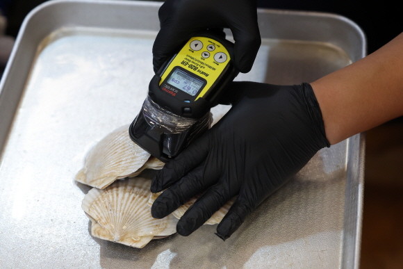 후쿠시마 제1원자력발전소 오염수의 해양 방류를 하루 앞둔 23일 오후 일본산 수산물에 대해 방사능 검사를 하는 모습. © 연합뉴스