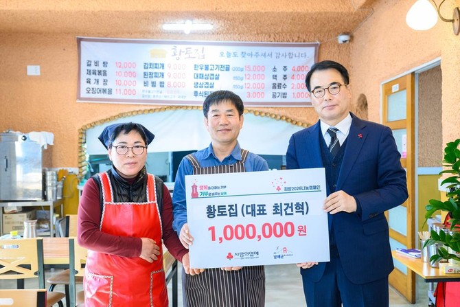 황토집 최건혁 대표가 '찾아가는 이웃사랑 기탁식'에서 100만원을 기탁하고 남해군수(오른쪽)와 기념촬영을 하고 있다. ⓒ 남해군